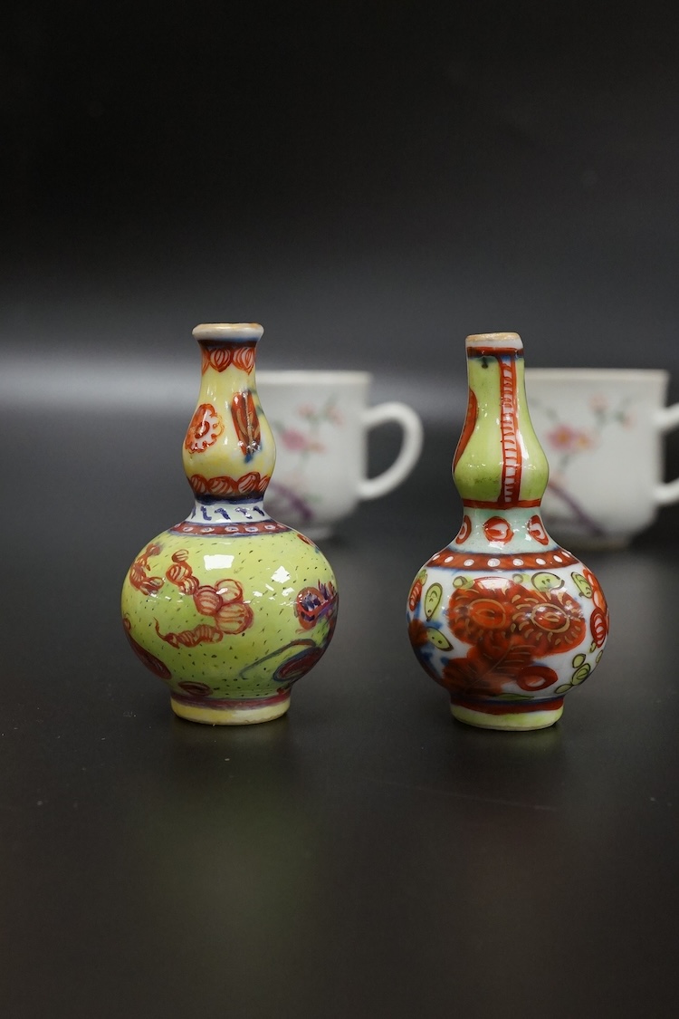 Two Chinese famille rose cups, Yongzheng period and two miniature clobbered vases, largest 6cm high